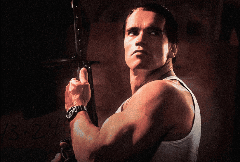 Arnold Schwarzenegger no filme Jogo Bruto (1986). Em uma lista 30 filmes indispensáveis da carreira.