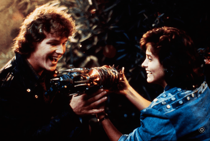 Robert Duncan McNeill (Kevin) e Courteney Cox (Julie Winston) em Mestres do Universo